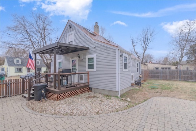 rear view of house with a deck and a patio