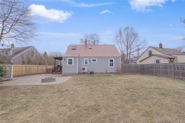 back of property featuring a fire pit, a patio area, and a yard