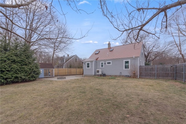 rear view of house with a lawn and an outdoor structure