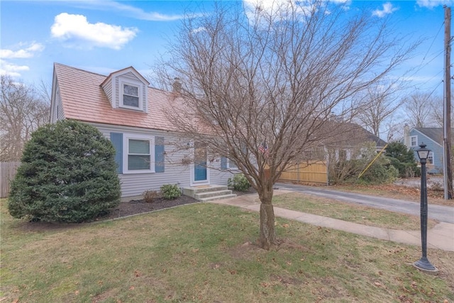 cape cod home with a front yard