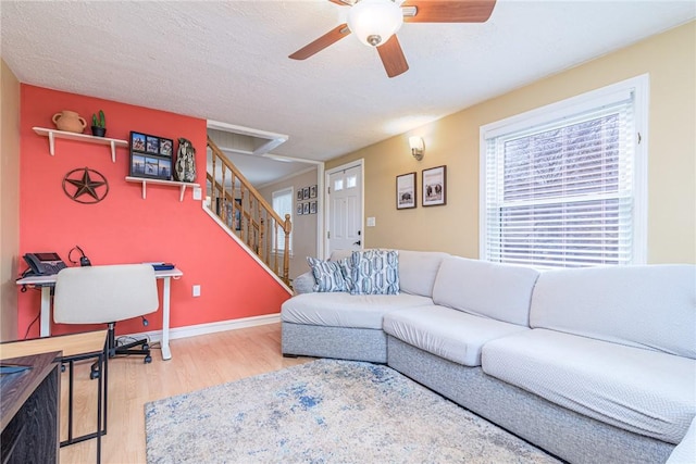 living room featuring ceiling fan and wood-type flooring