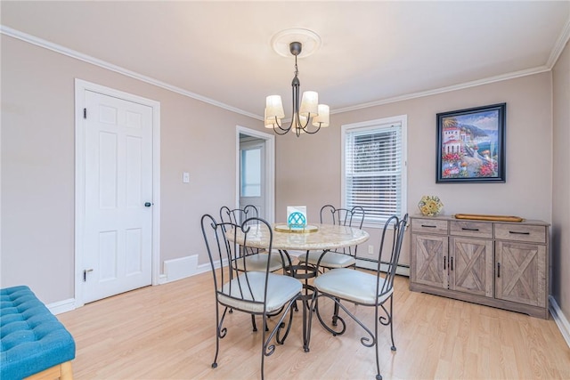 dining room with a notable chandelier, light wood-type flooring, ornamental molding, and a baseboard heating unit