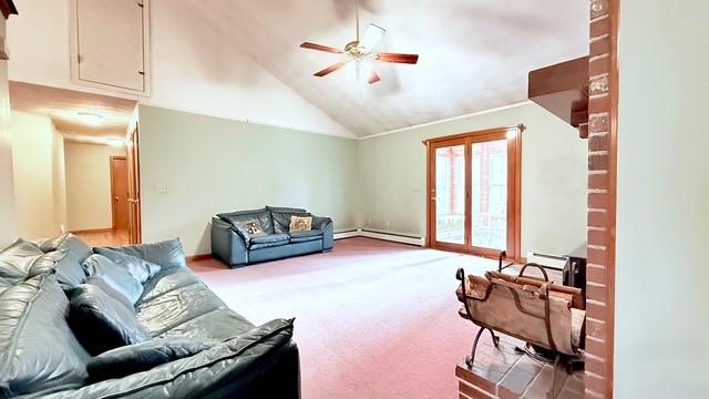 living room with lofted ceiling, a baseboard heating unit, light colored carpet, and ceiling fan