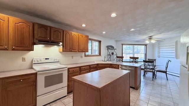 kitchen featuring ceiling fan, a center island, white electric range oven, light tile patterned flooring, and stainless steel dishwasher