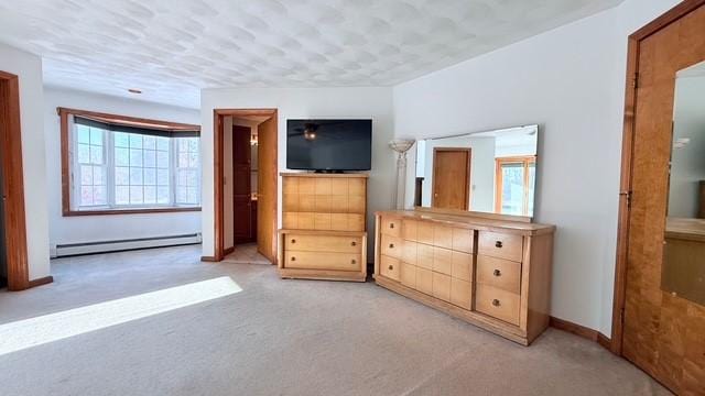 unfurnished bedroom with light carpet and a baseboard heating unit