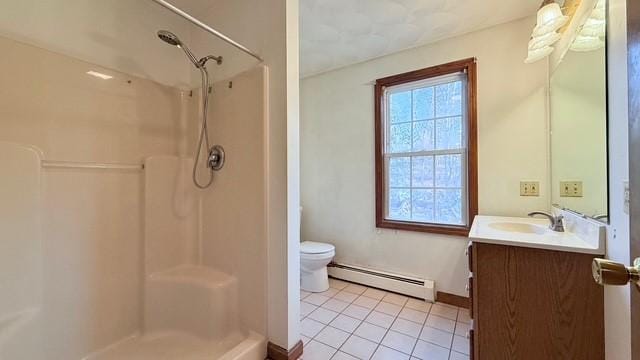 bathroom with tile patterned flooring, vanity, walk in shower, baseboard heating, and toilet