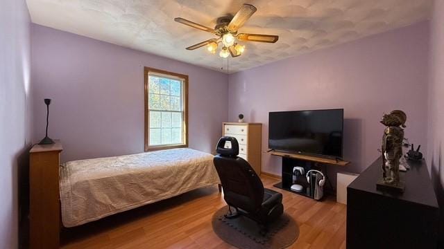 bedroom featuring hardwood / wood-style floors and ceiling fan