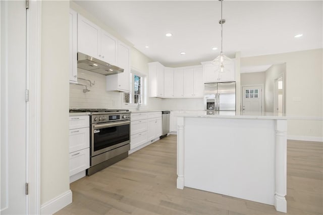 kitchen featuring white cabinetry, a center island, pendant lighting, and appliances with stainless steel finishes