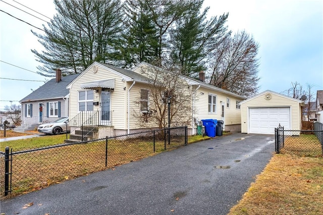 single story home featuring a front yard, a garage, and an outbuilding