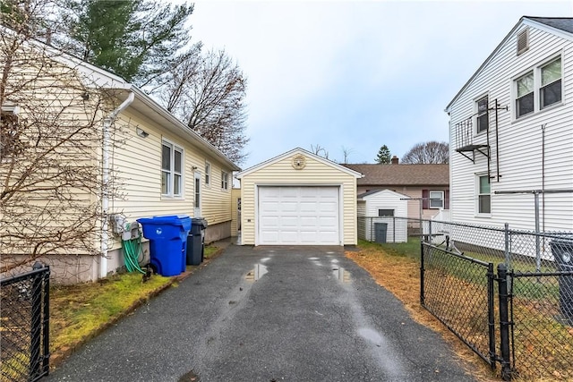 view of side of property with a garage and an outbuilding