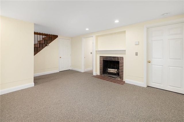 unfurnished living room featuring carpet flooring and a brick fireplace