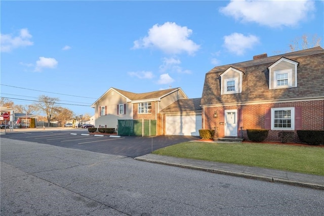 view of front of house featuring a garage and a front yard