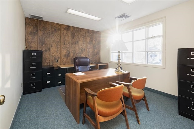 office area with wood walls and carpet floors