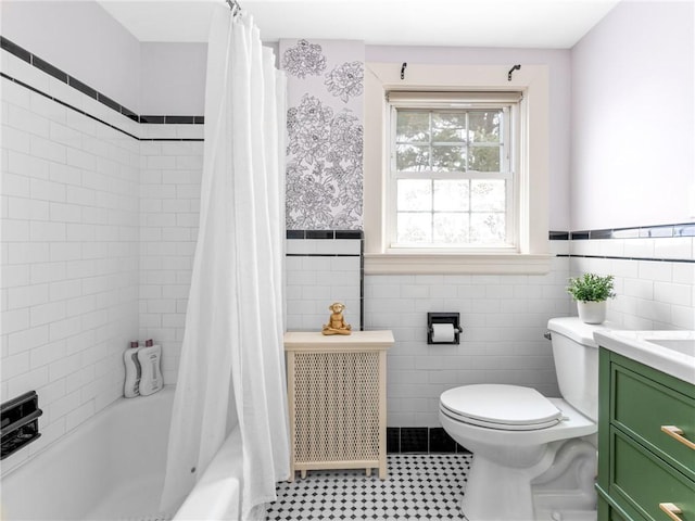 full bathroom with tile walls, shower / tub combo, vanity, and toilet