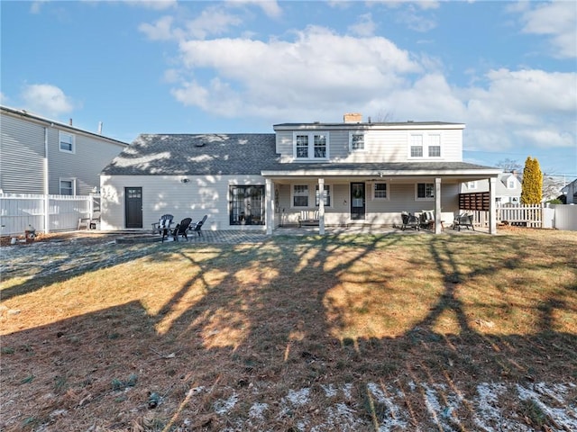 back of house with a yard and a patio