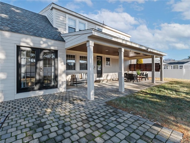 rear view of property featuring french doors and a patio area