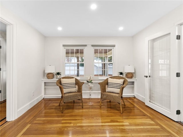 sitting room with wood-type flooring