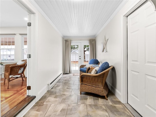 sitting room featuring a baseboard heating unit, french doors, and crown molding