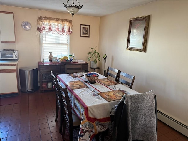 tiled dining area with a baseboard radiator