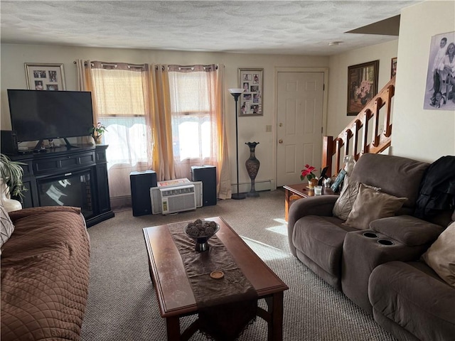 carpeted living room featuring a textured ceiling and baseboard heating