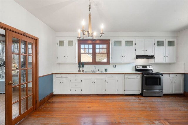 kitchen featuring electric range, an inviting chandelier, white dishwasher, hanging light fixtures, and white cabinets