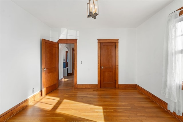 empty room with hardwood / wood-style floors