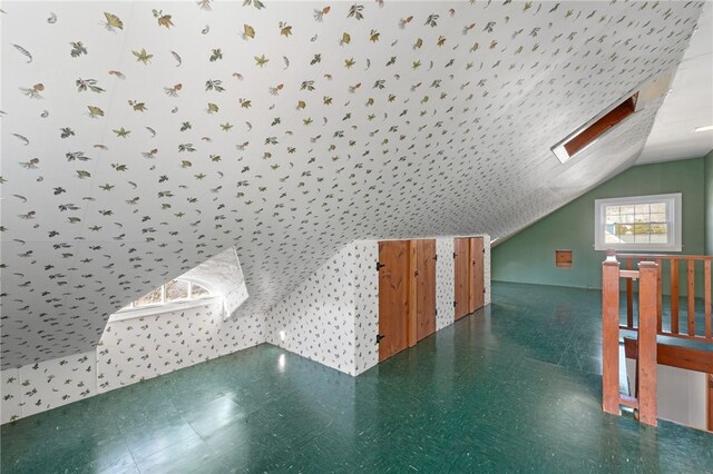 bonus room with lofted ceiling with skylight