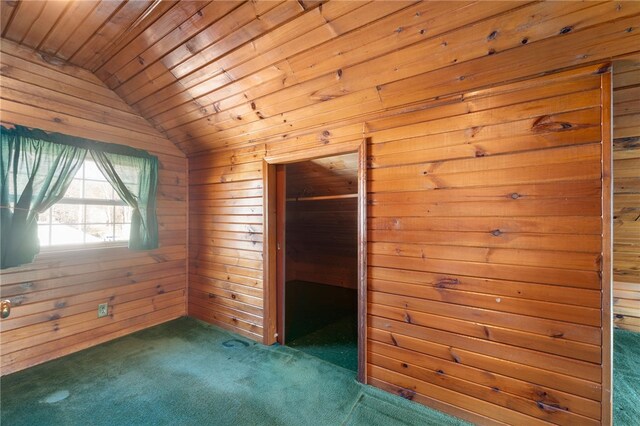 interior space featuring vaulted ceiling, wooden ceiling, wood walls, and dark colored carpet