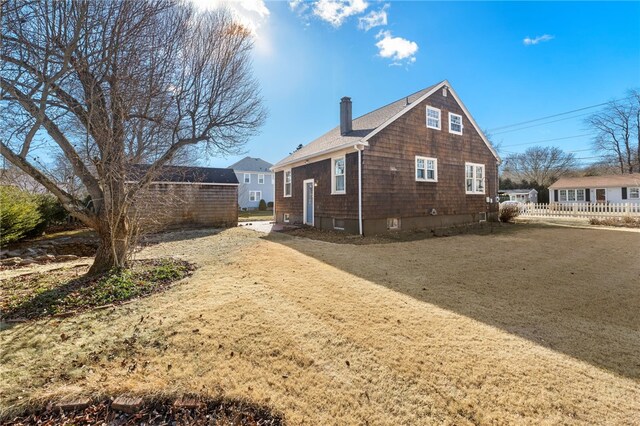 back of house featuring a lawn