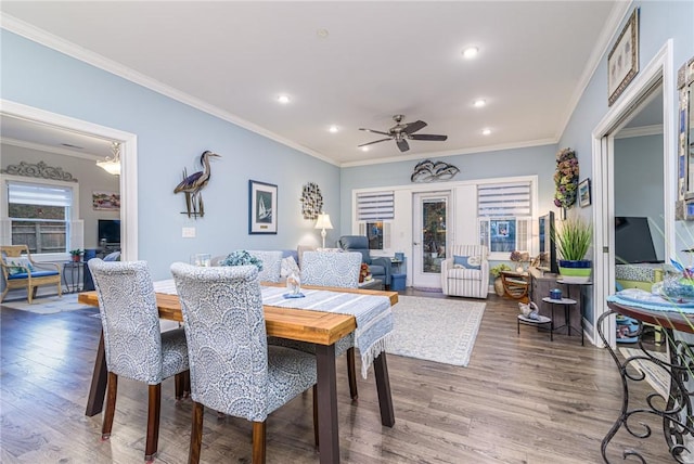 dining space with ornamental molding, ceiling fan, and wood-type flooring