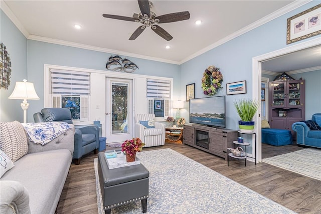 living room with dark hardwood / wood-style flooring, ceiling fan, and crown molding