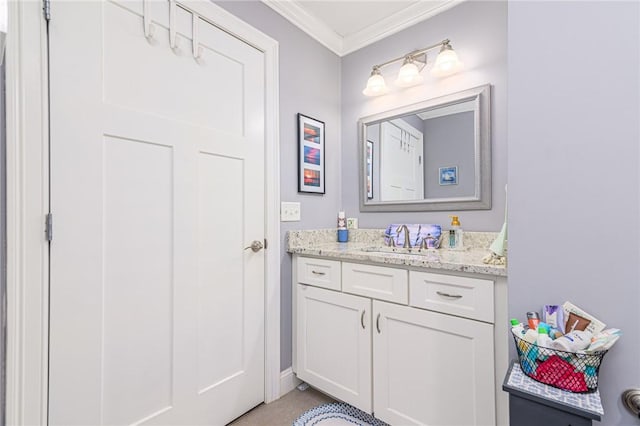 bathroom with vanity and ornamental molding