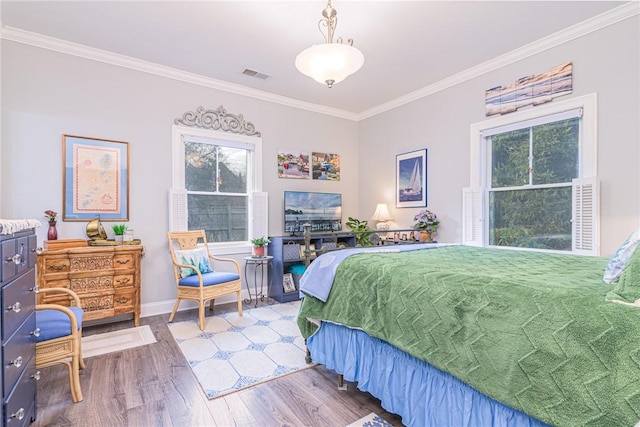 bedroom with ornamental molding and wood-type flooring