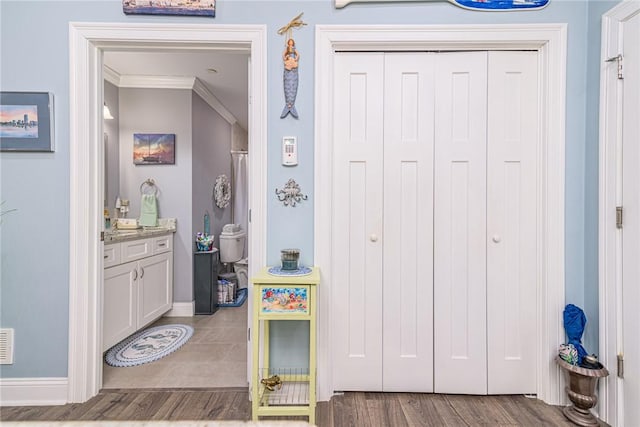 bathroom featuring ornamental molding and vanity