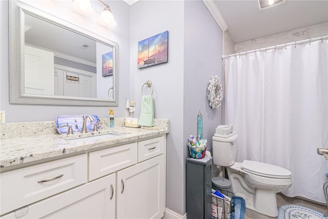 bathroom with ornamental molding, curtained shower, vanity, and toilet