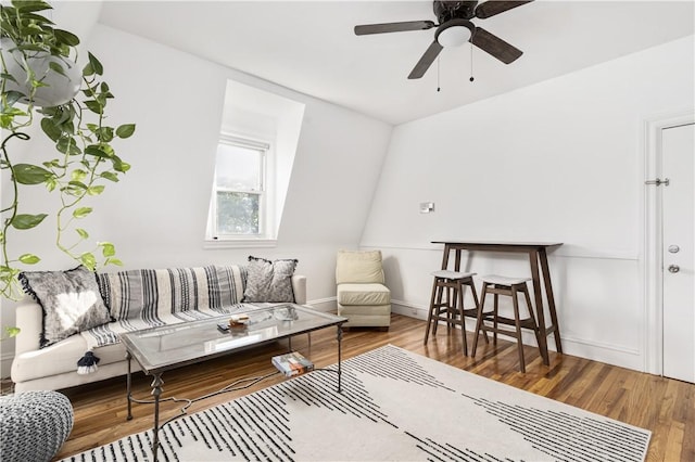 living area with hardwood / wood-style flooring and ceiling fan