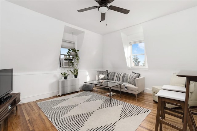 living room featuring radiator, ceiling fan, hardwood / wood-style floors, and cooling unit