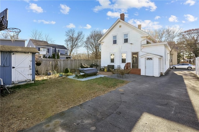 exterior space featuring a yard, a patio, and a storage shed