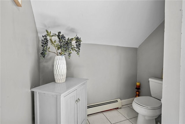 bathroom with toilet, vaulted ceiling, tile patterned floors, and baseboard heating