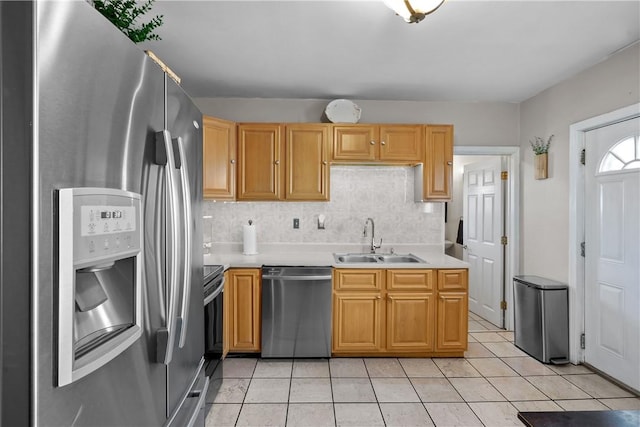 kitchen featuring dishwasher, light tile patterned flooring, sink, stainless steel fridge, and electric range oven