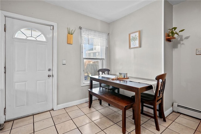 dining space featuring light tile patterned floors and a baseboard radiator