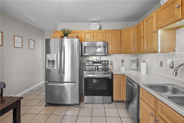 kitchen with light tile patterned floors, backsplash, stainless steel appliances, and sink