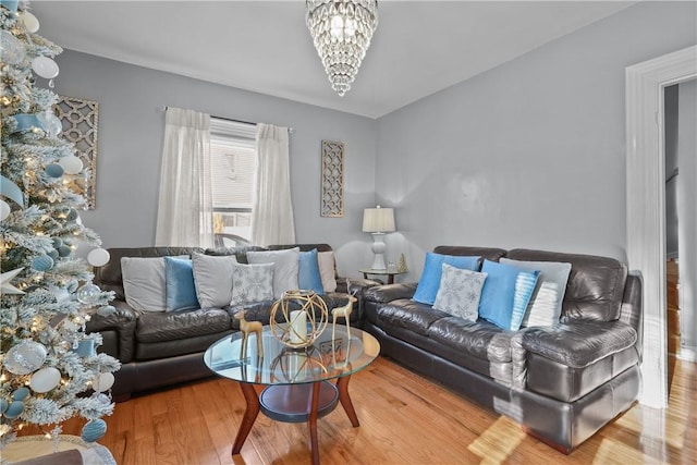 living room with hardwood / wood-style flooring and an inviting chandelier