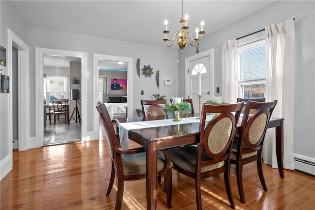 dining room featuring light hardwood / wood-style flooring and a chandelier