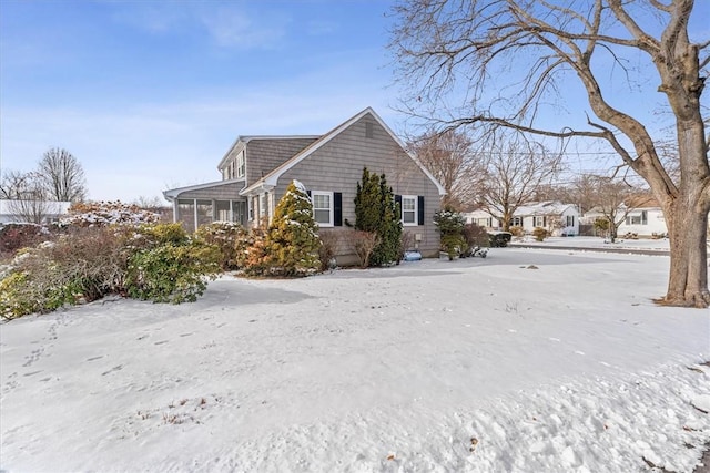 view of snow covered exterior featuring a sunroom