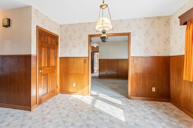 spare room featuring wood walls