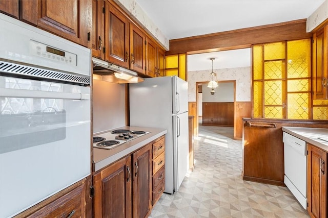 kitchen featuring pendant lighting and white appliances