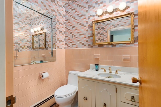 bathroom featuring toilet, vanity, tile walls, and a baseboard radiator