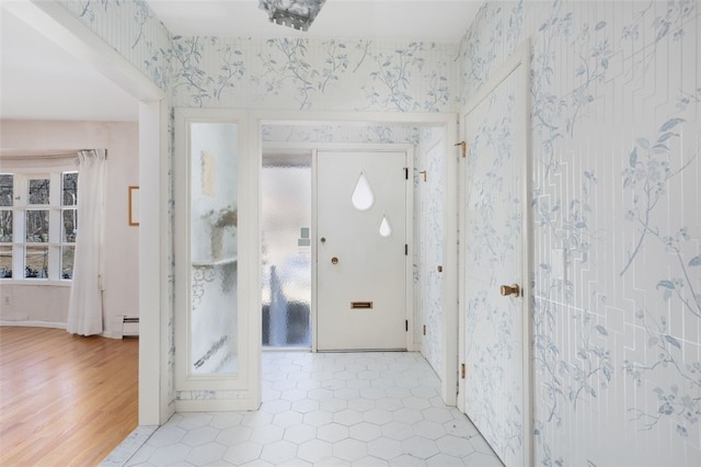 tiled foyer entrance featuring a baseboard heating unit