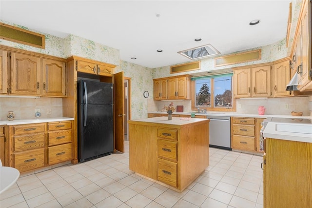 kitchen with stainless steel dishwasher, black fridge, light tile patterned floors, decorative backsplash, and a kitchen island